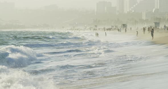 Waves reaching the shore on the beach alt