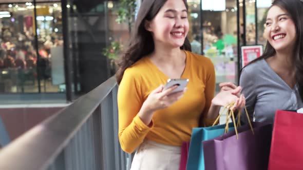 Asian woman wearing face mask. Happy woman with shopping bags