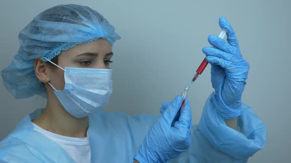 Scientist takes blood samples for Covid 19 vaccination, Coronavirus Pandemic vaccine for 2019-nCoV.