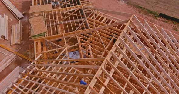 Aerial Top View of Under Construction Under Framing New Wooden Roof Beams Built Home