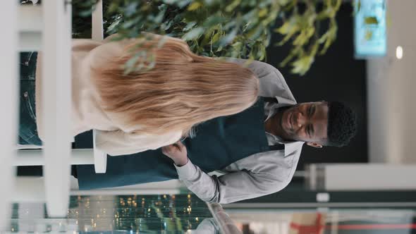 Vertical View Young Smiling Friendly African American Male Waiter in Cafe Brings Coffee in