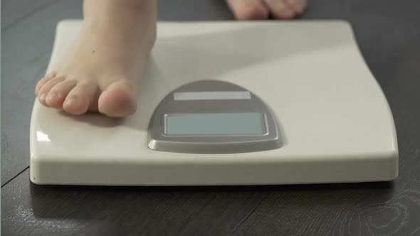 Woman Stepping on Scales to See Weight Control Results, Healthy Dieting