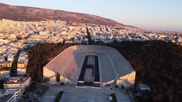 Orbiting drone video of the the Panathenaic Stadium in Athens, Greece during a sunset.