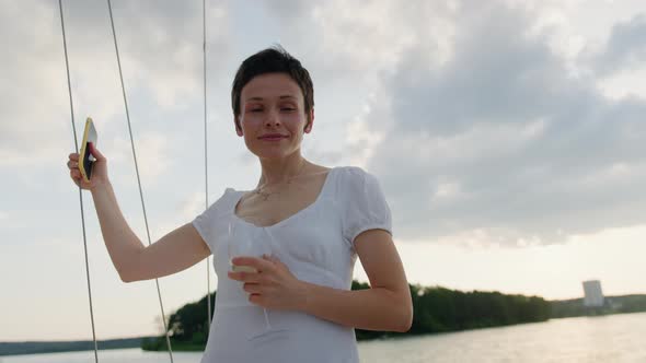 Portrait of a Shorthaired Brunette in a White Dress on a Yacht