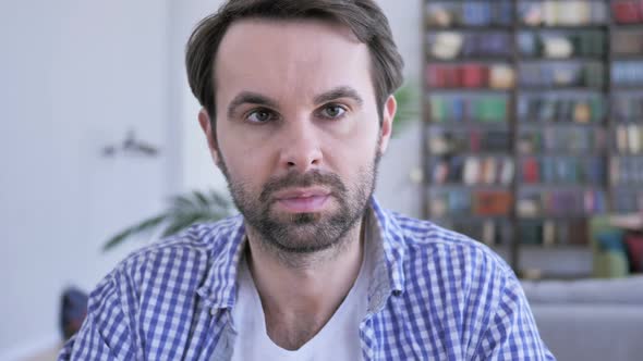 Portrait of Serious Casual Beard Man Looking at Camera