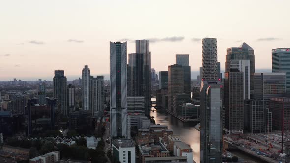 Slide and Pan Footage of Modern Tall Buildings Along South Dock Water Channel in Sunset Time
