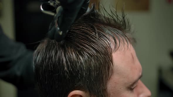 Crop Barber Cutting Hair of Anonymous Man