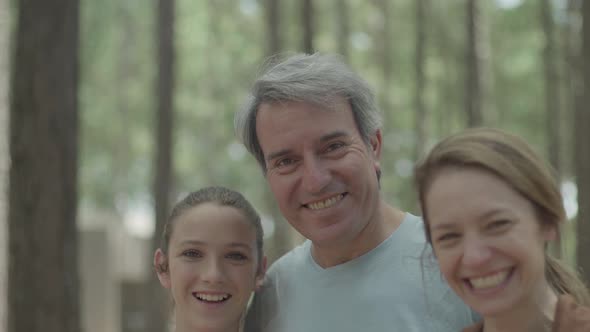 Parents and daughter in woods, portrait