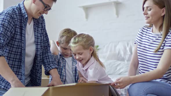 Funny Children Unpacking Box