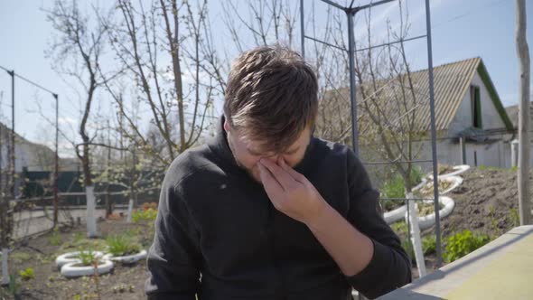 Portrait of Ill Caucasian Man Sneezing and Rubbing Nose. Young Brunette Handsome Guy Agree with