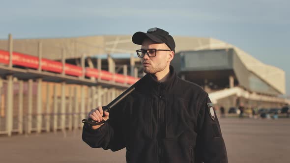 A Man in a Police Uniform is Walking and Looking Around