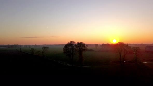 Aerial Cinematic Clip Drone Flying Over a Farm Field During Sunset