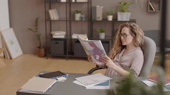 Expecting Office Worker Reading Maternity Book