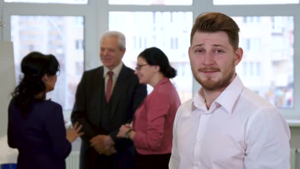 Young Guy Looks at Business People