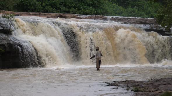 Man fishing around the Farako falls