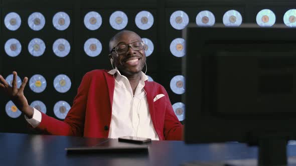 Africanamerican Man Listens to Music Sings Dances Sitting at Desktop