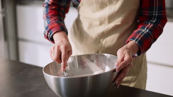 Young Housewife Mixing Cake Ingredients in Bowl