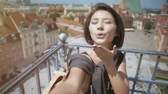 Europe Lifestyle. Happy Tourist Woman Taking Selfies on Phone on Balcony Overlooking Beautiful