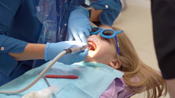 Little Girl with Oral Dilator at Dentist's Appointment