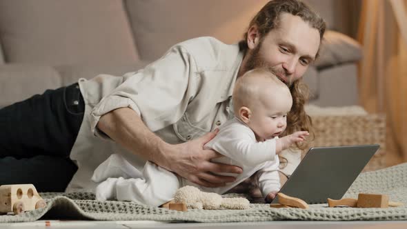 Adult Caucasian Dad Bearded Single Father with Newborn Baby Making Video Call to Mother or Relatives