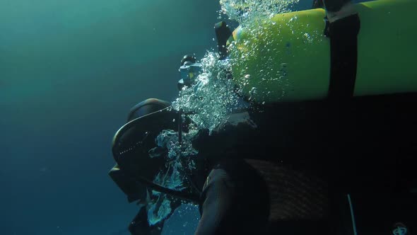 Professional Scuba Diver are Submerged Underwater with Oxygen Tank