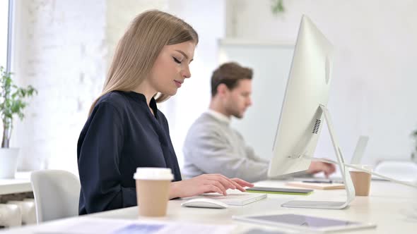 Focused Creative Woman Working on Desktop in Modern Office