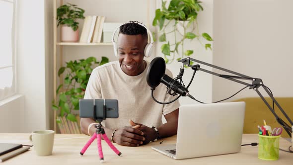 Happy Young African Man Making Audio Podcast From Home Studio