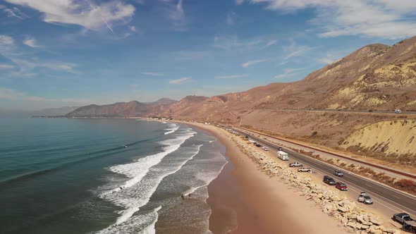 Aerial shot of pacific coast highway along southern California beach.