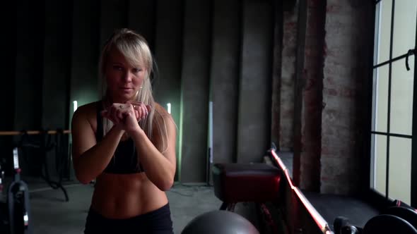 Close-up Portrait of a Sporty Woman Blonde Boxer Imitates Punches, She Is in the Hall. The Concept