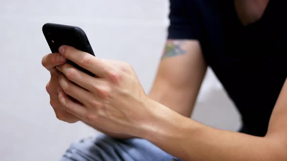 Man Use Smart Phone in Toilet, Surfing Internet. Close-up of Male Hands Holding Phone