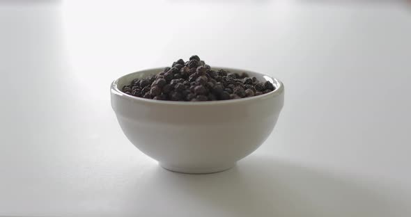 Peppercorns in a white bowl
