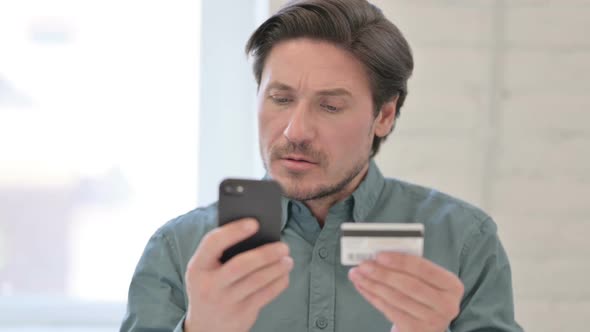 Portrait of Middle Aged Man with Unsuccessful Online Shopping on Smartphone