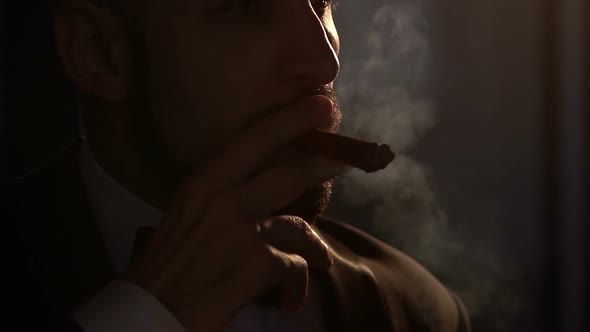Silhouette of Bearded Caucasian Man Who Smoking a Cigar Slow Motion