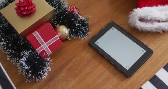 Tablet with copy space and christmas decoration on wooden table