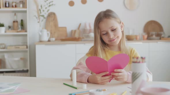 Pretty Little Girl Making Heart-Shaped Card