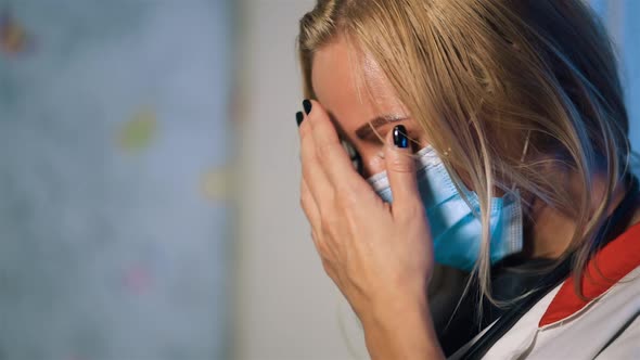 Broken Female Doctor in Surgical Mask Feeling Down