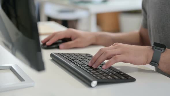 Hands of Young Man Using Mouse and Keyboard Close Up