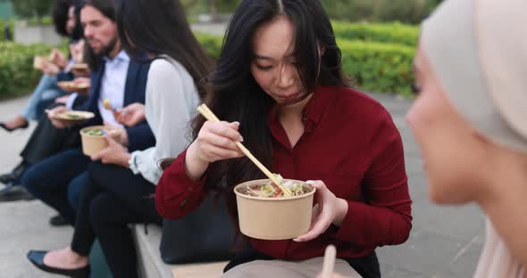 Multiethnic business people doing lunch break outdoor from office building