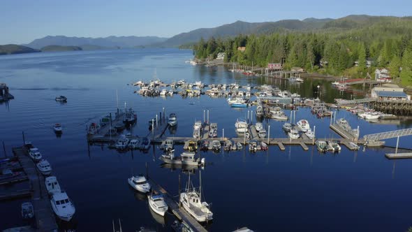 Drone pull back shot of an Alaskan cove full of fishing boats on a rare Sunny day in South Eastern A