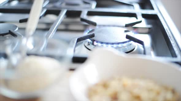 Frying pan being put on gas stove