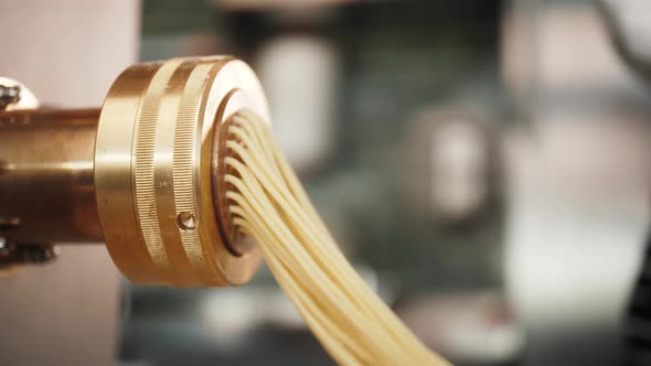 Man Making Fresh Pasta on Traditional Italian Kitchen Machine for Spaghetti Chef Preparing Fresca