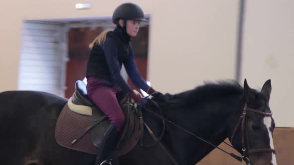 Girl riding her horse on hippodrome