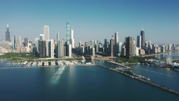 Cinematic Sunlight Reflecting at Glass Skyscrapers Drone Above Lake Michigan