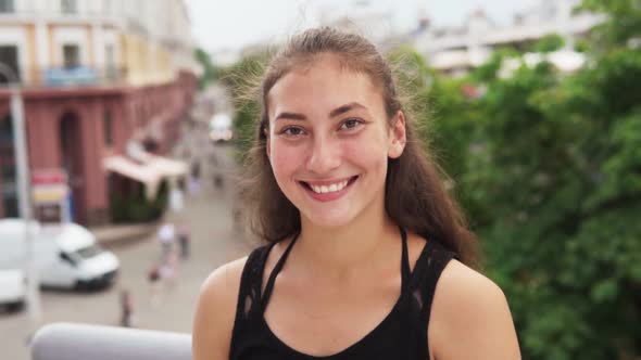 Happy Mixed Race Girl Smiling at City Street