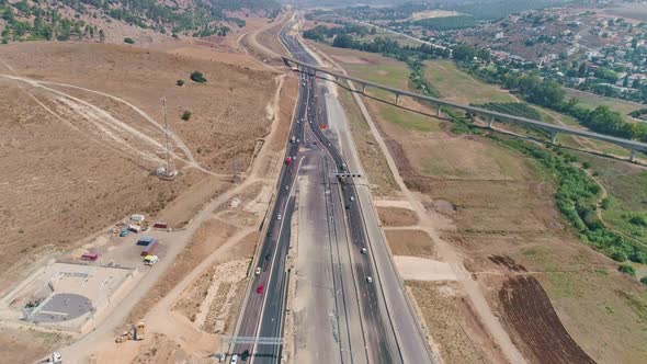 Aerial footage of large highway construction project with tunnels and bridges