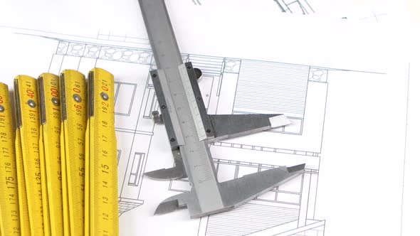 Calliper and Part of Yellow Folding Rule on the Building Plan, Scheme, Rotation