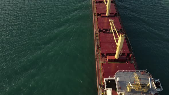 Freighter driving on Detroit River near Wyandotte, Michigan, USA, Flyover Aerial Shot
