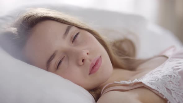 Close Up of Beautiful Girl Waking Up and Looking at Camera