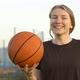 Young girl holding basketball ball looking positive and happy - VideoHive Item for Sale