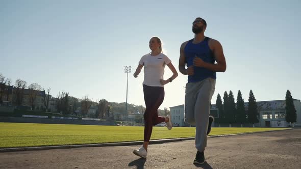 Couple of Joggers in Stadium